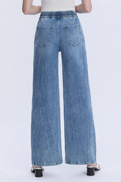 Wide-leg jeans worn by a person on a white background