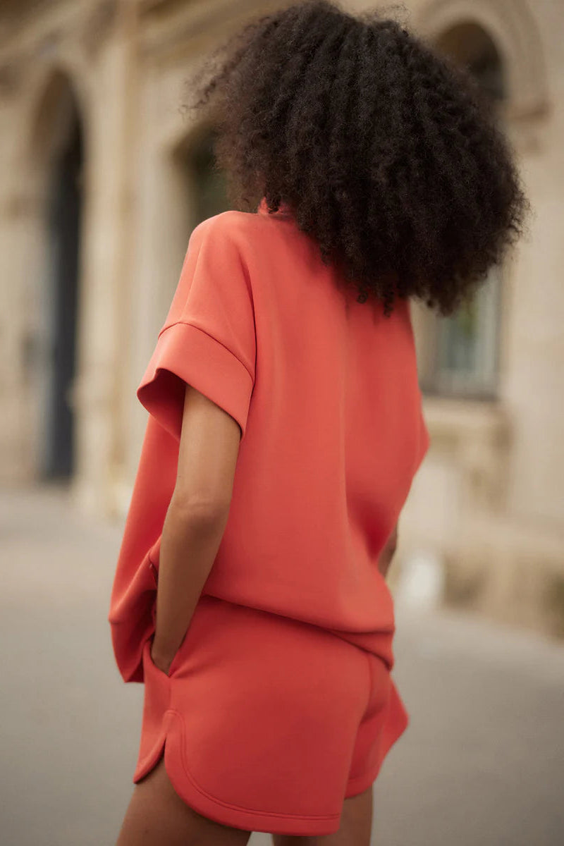 woman wearing red top and red shorts