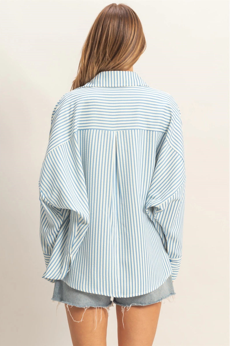 Person wearing a striped shirt and shorts on a plain background