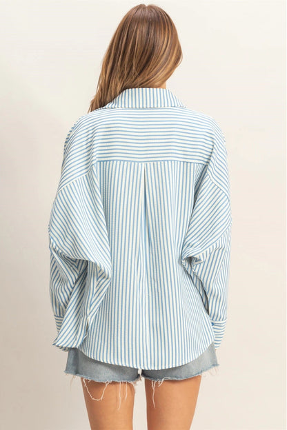 Person wearing a striped shirt and shorts on a plain background