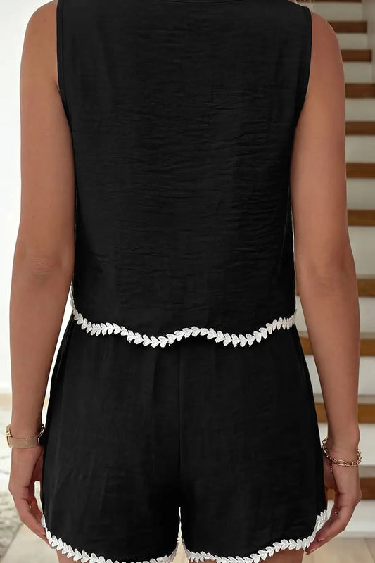 woman wearing black tank and shorts with white contrast