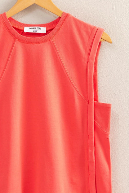 Red sleeveless top on a hanger against a white wall