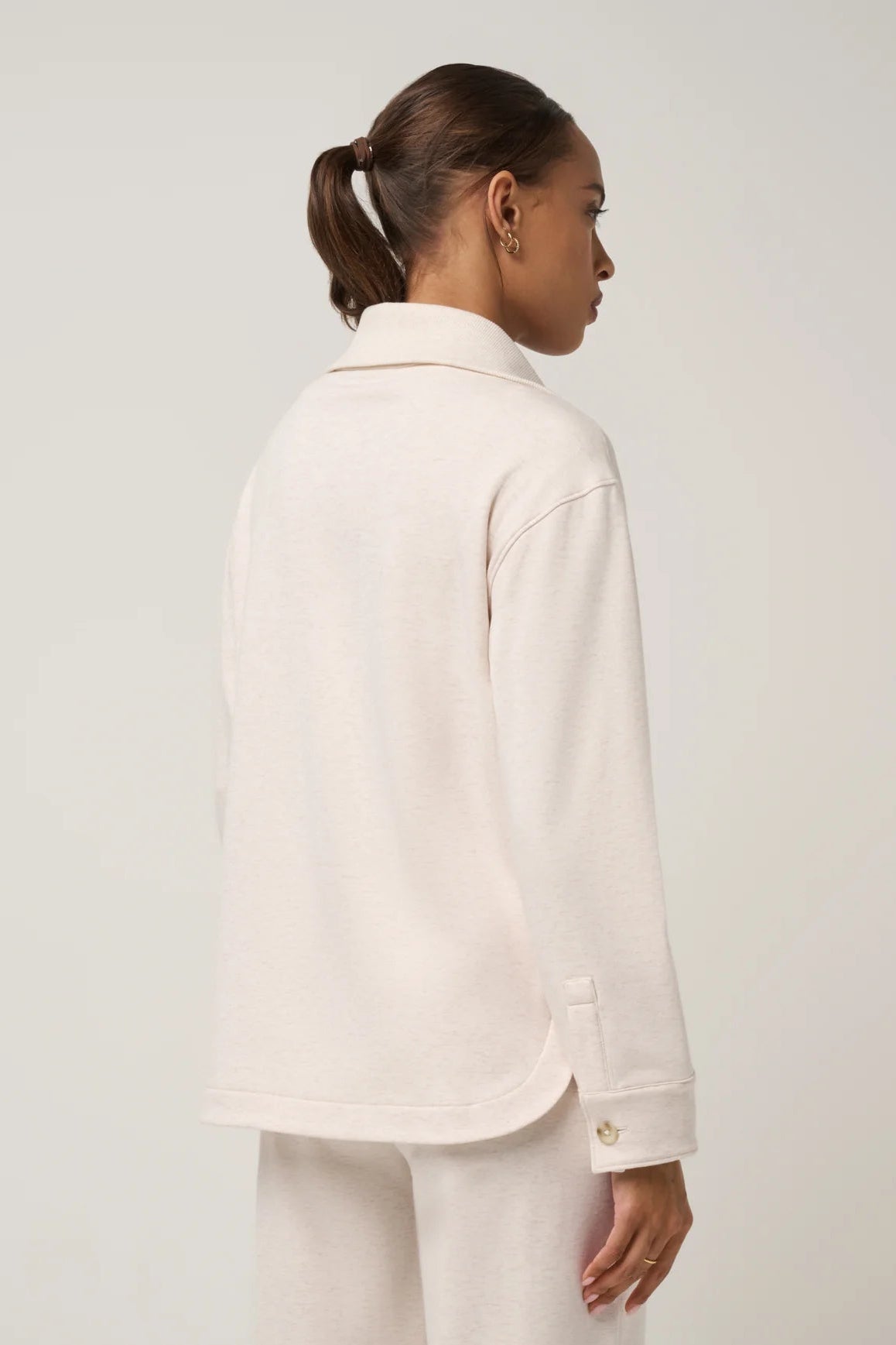 back view of woman in collared shirt 