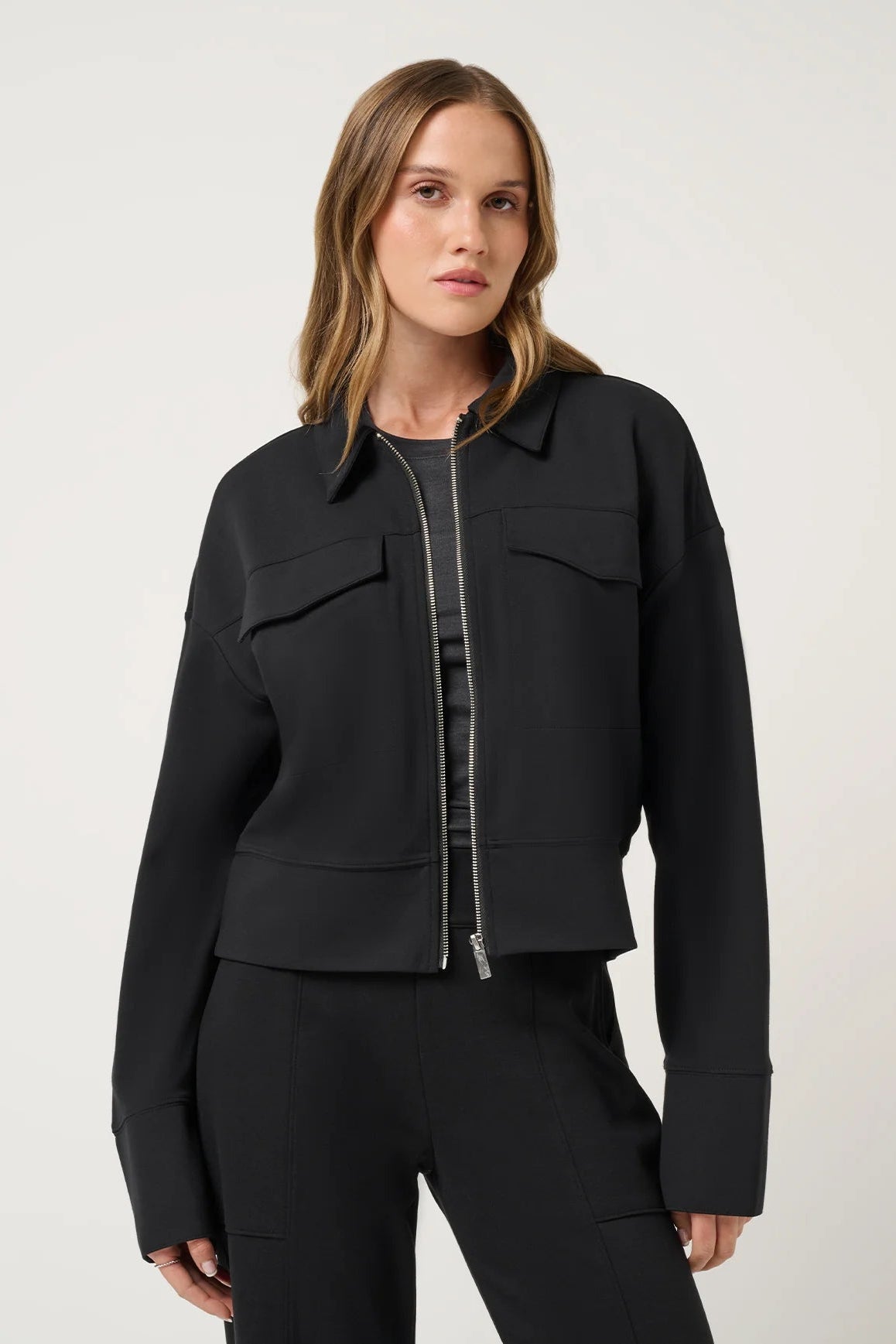 woman in black jacket and pants
