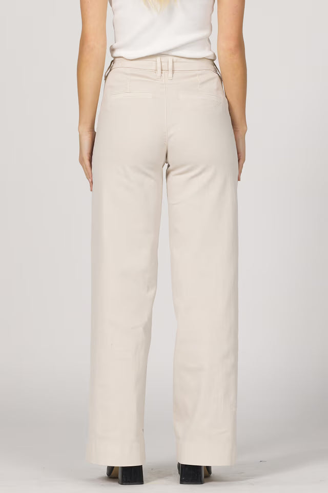 Beige pants worn by a person on a white background