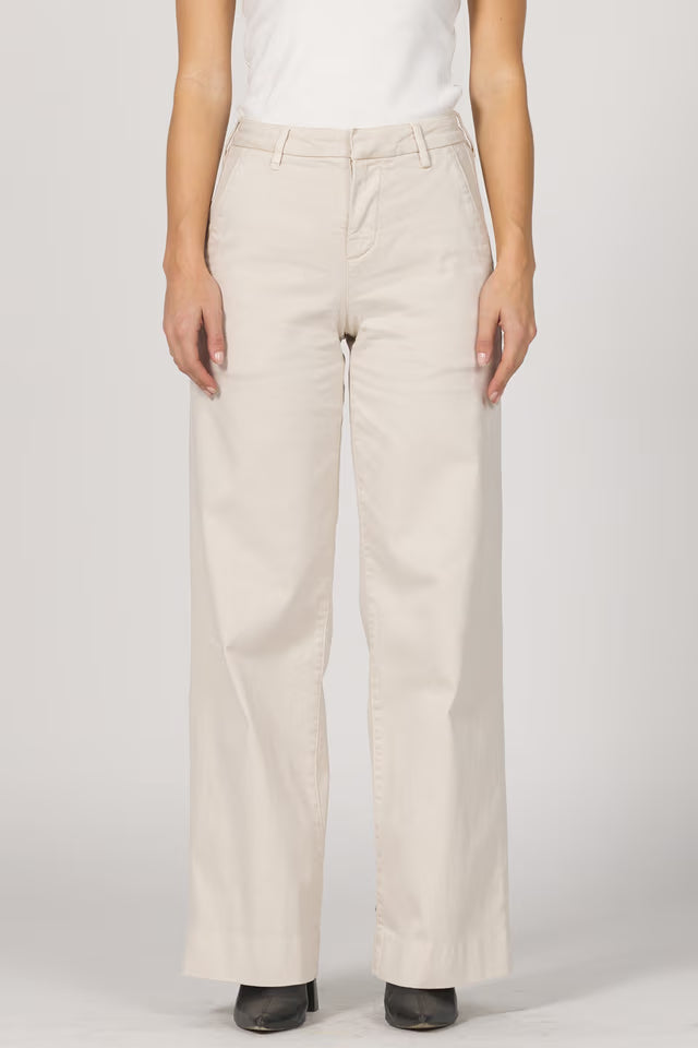 Beige pants worn by a person on a white background