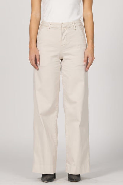 Beige pants worn by a person on a white background