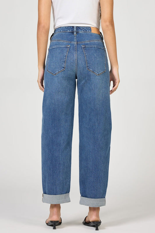 Blue jeans worn by a person on a white background