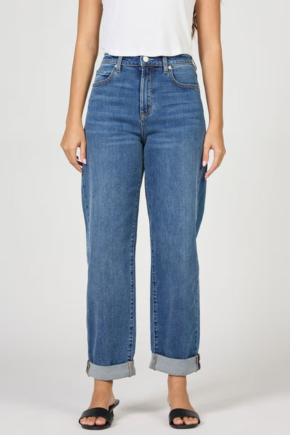 Blue jeans worn by a person on a white background