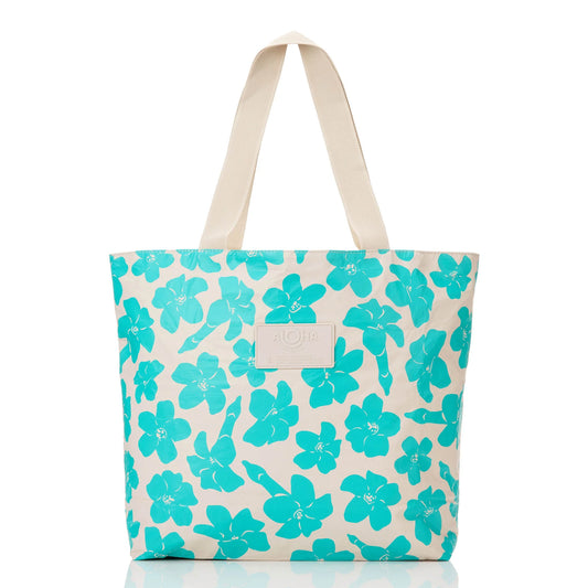 Tote bag with turquoise floral pattern on a white background