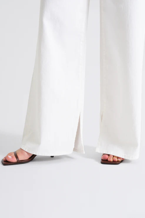 White pants worn by a person on a white background