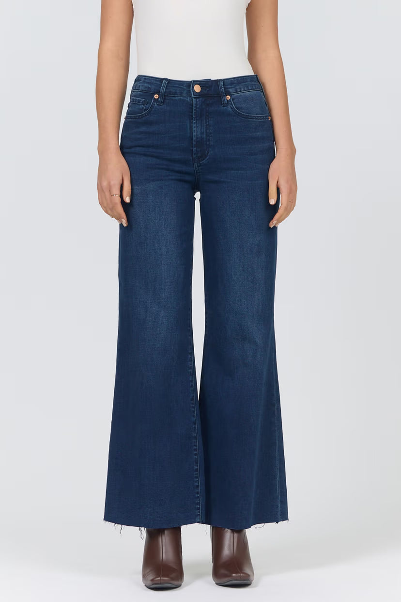 person wearing dark wash jeans