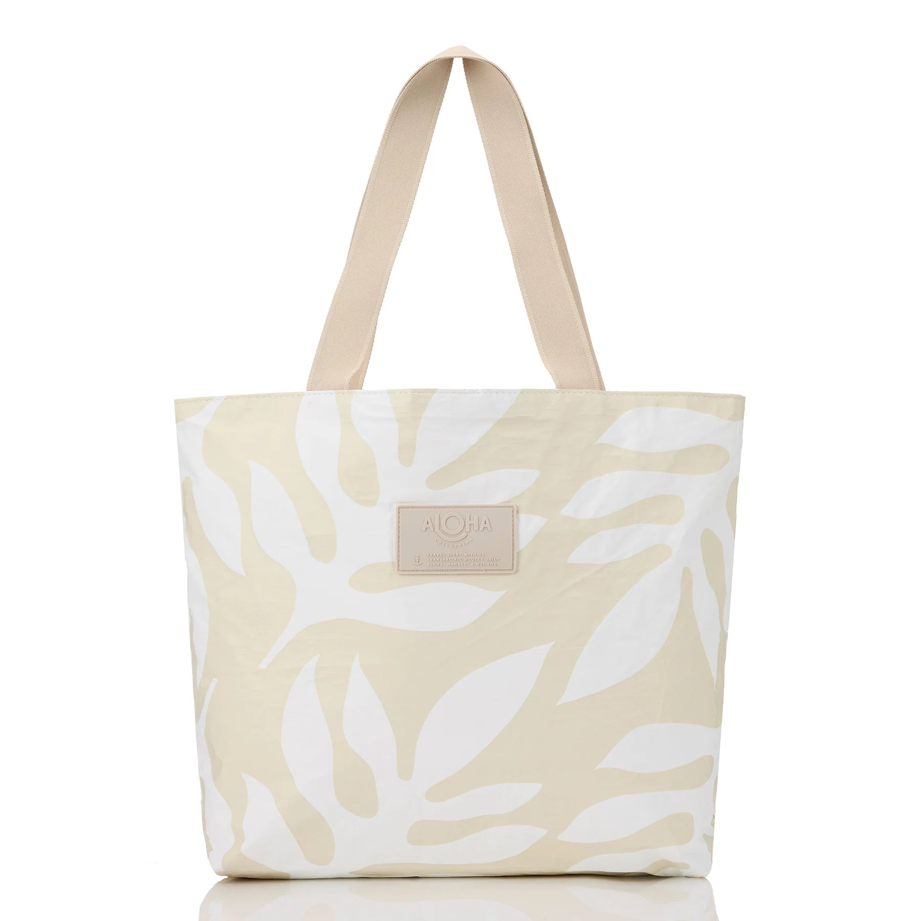 Beige tote bag with white leaf pattern on a white background