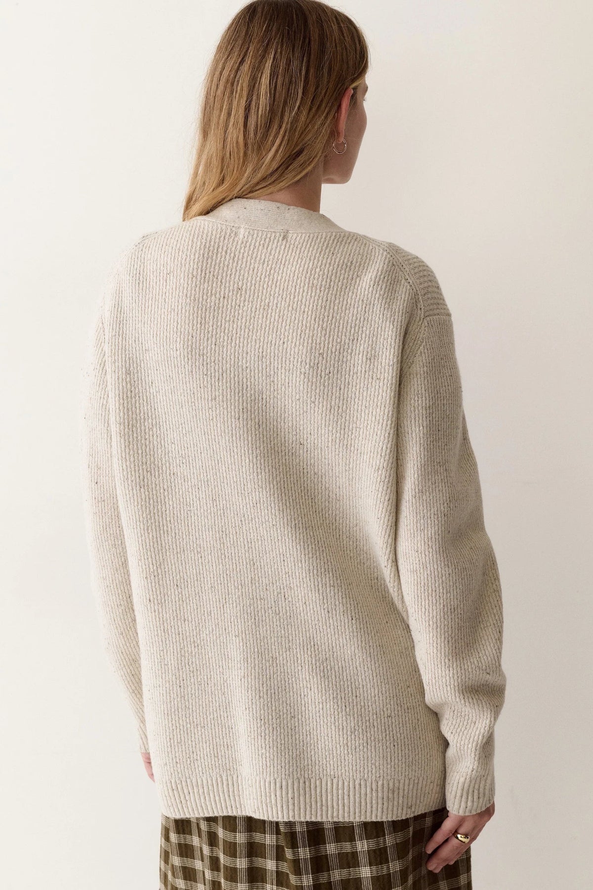 back view of woman in cardigan and dress