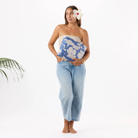 Woman holding a blue and white floral towel with a white background