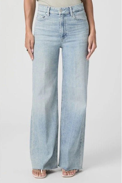 Light blue jeans worn by a person on a white background