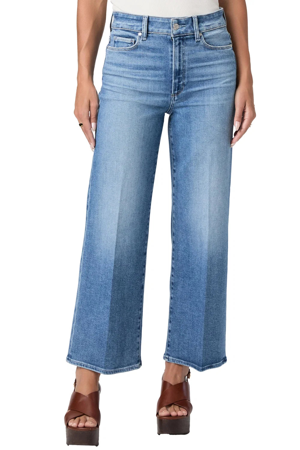 Blue jeans worn by a person on a white background