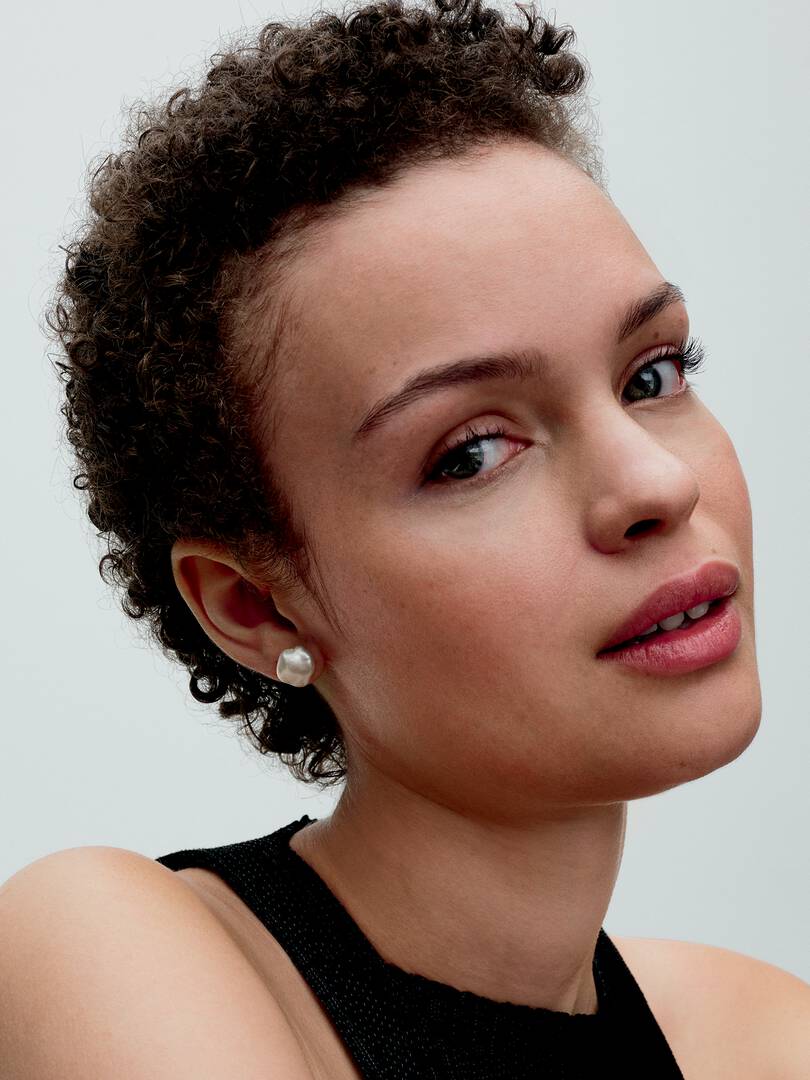 woman wearing pearl stud earrings