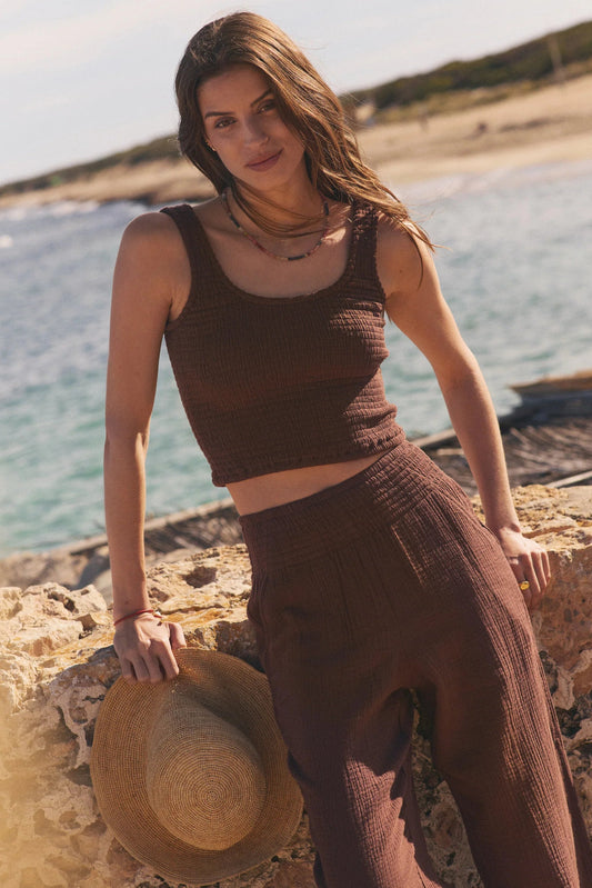 woman wearing brown tank and brown pants 