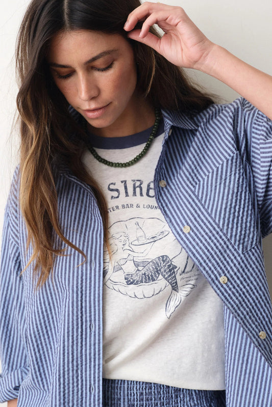woman wearing tee with striped blue button down