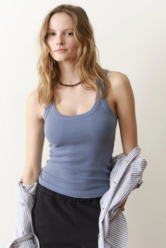 woman wearing blue tank with black pants