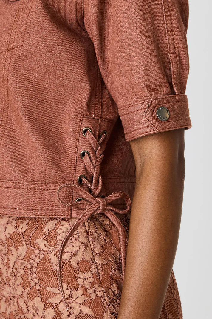 Brown lace-up dress with a plain background