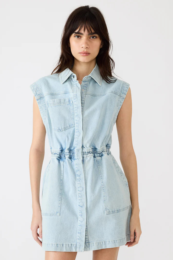 Woman wearing a light blue denim dress on a white background