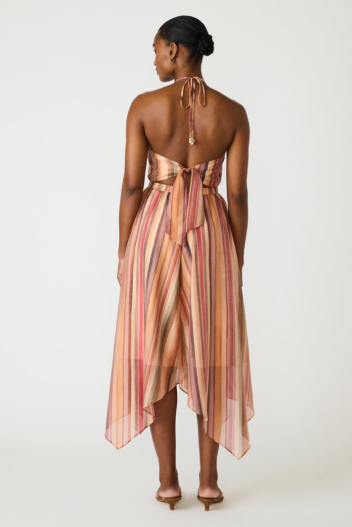 Woman wearing a striped dress with a white background