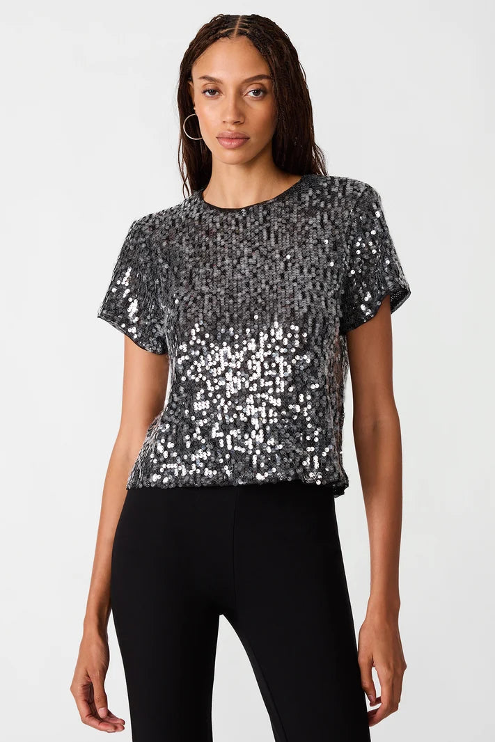 woman wearing sequin top with black pants