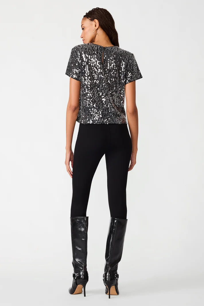 woman wearing sequin top with black pants