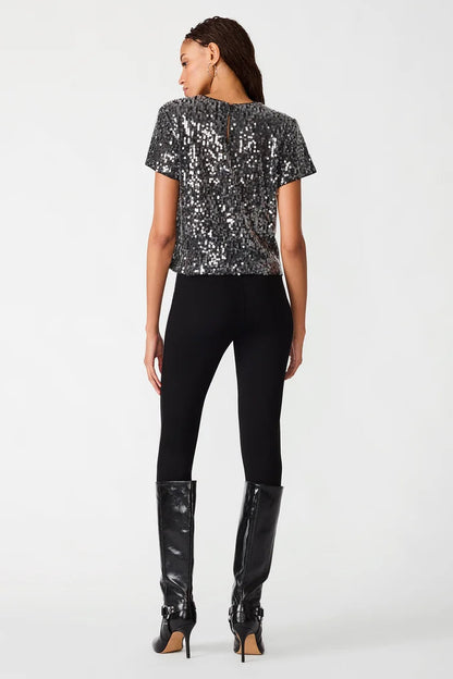 woman wearing sequin top with black pants