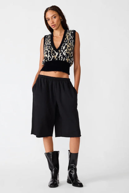 woman wearing leoprard print vest with black pants and boots