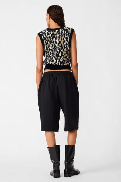 back view of woman in leopard print vest and pants
