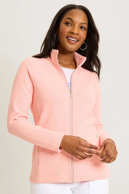 Woman wearing a pink jacket on a plain background