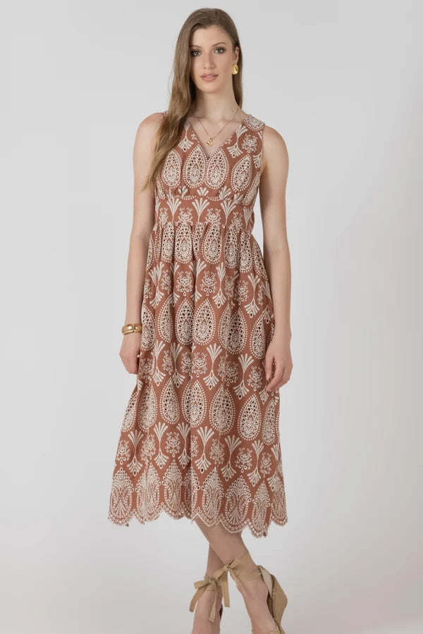 Woman wearing a patterned dress on a white background