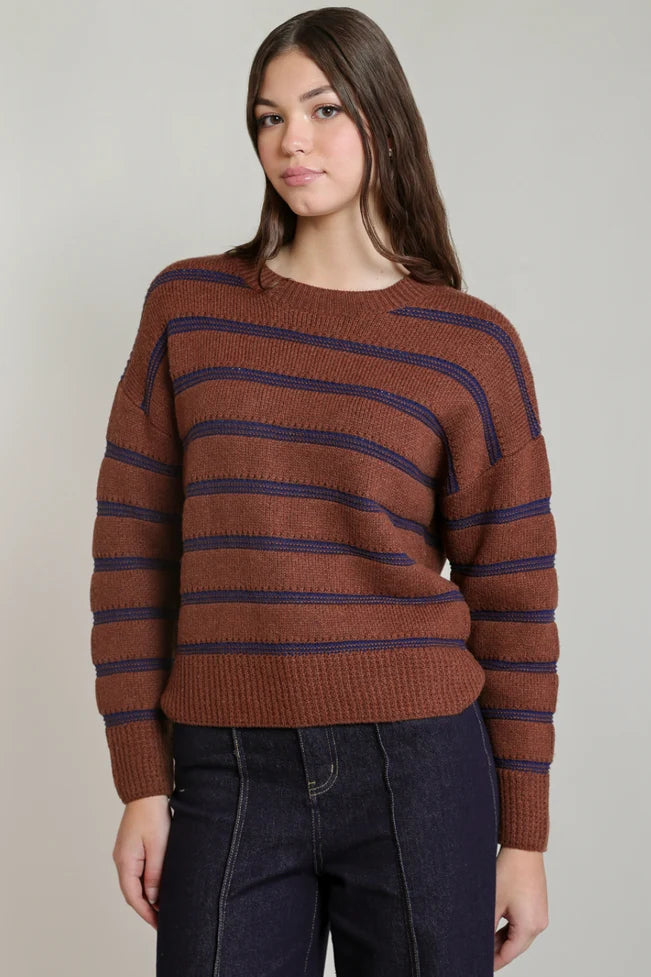 woman wearing brown and blue sweater with jeans