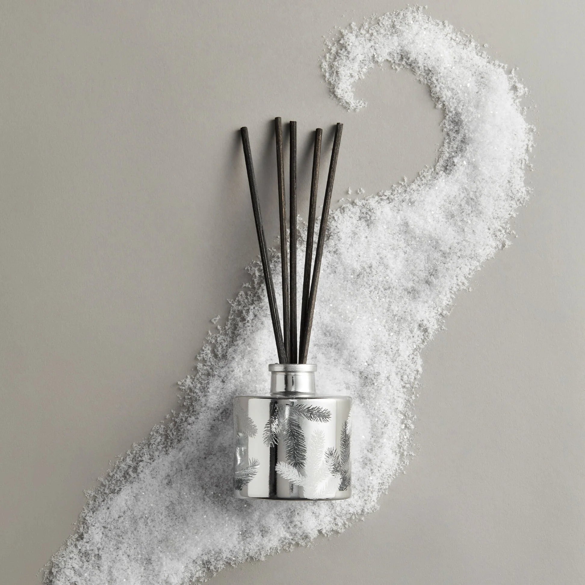 Diffuser with black sticks on a gray background