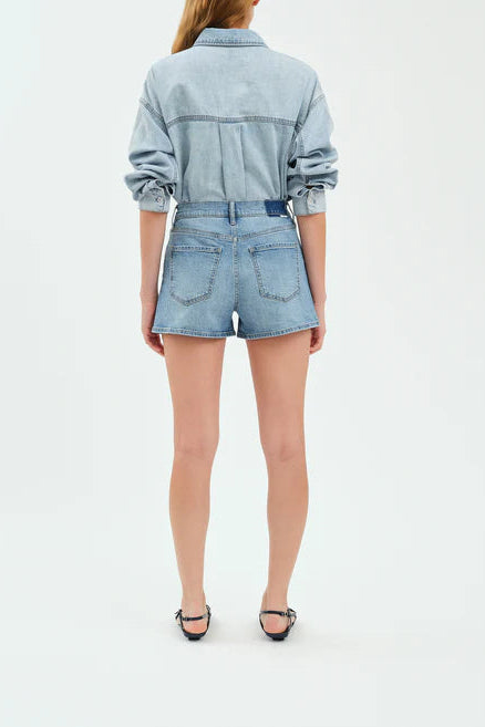 Person wearing a denim outfit on a white background