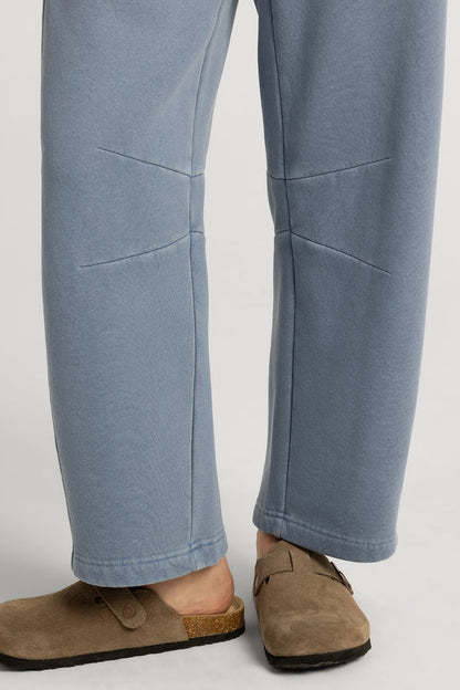 Light blue pants worn by a person on a white background