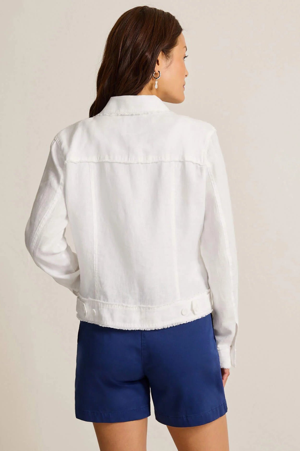 woman wearing white jacket with blue shorts
