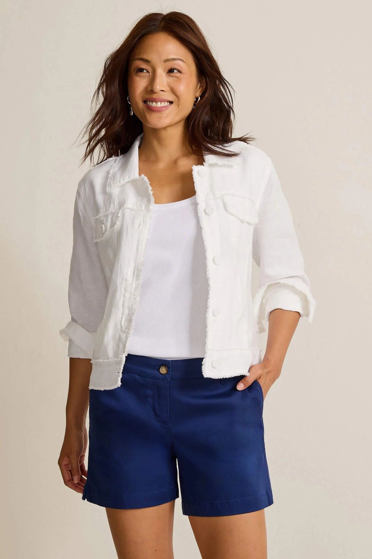 woman wearing white jacket with blue shorts