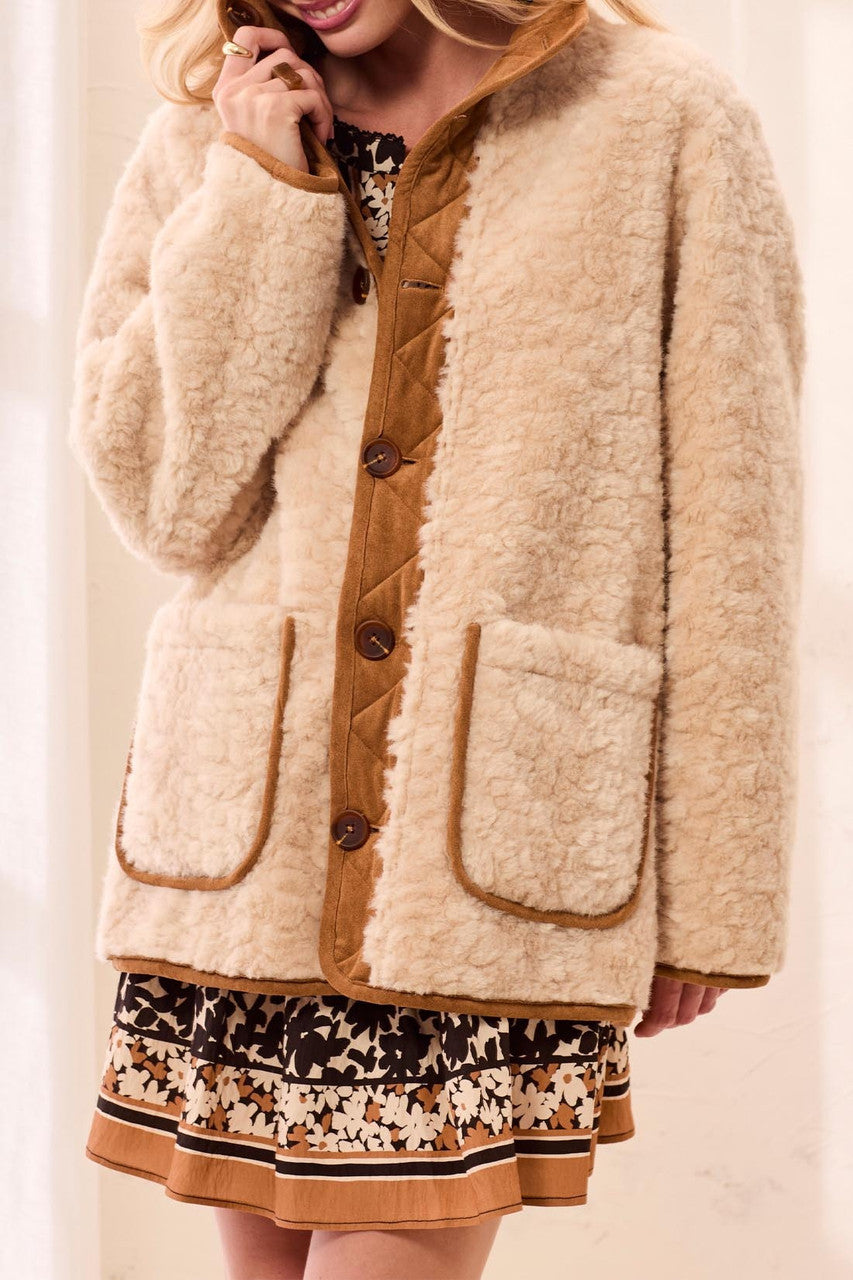 woman wearing sherpa coat with dress