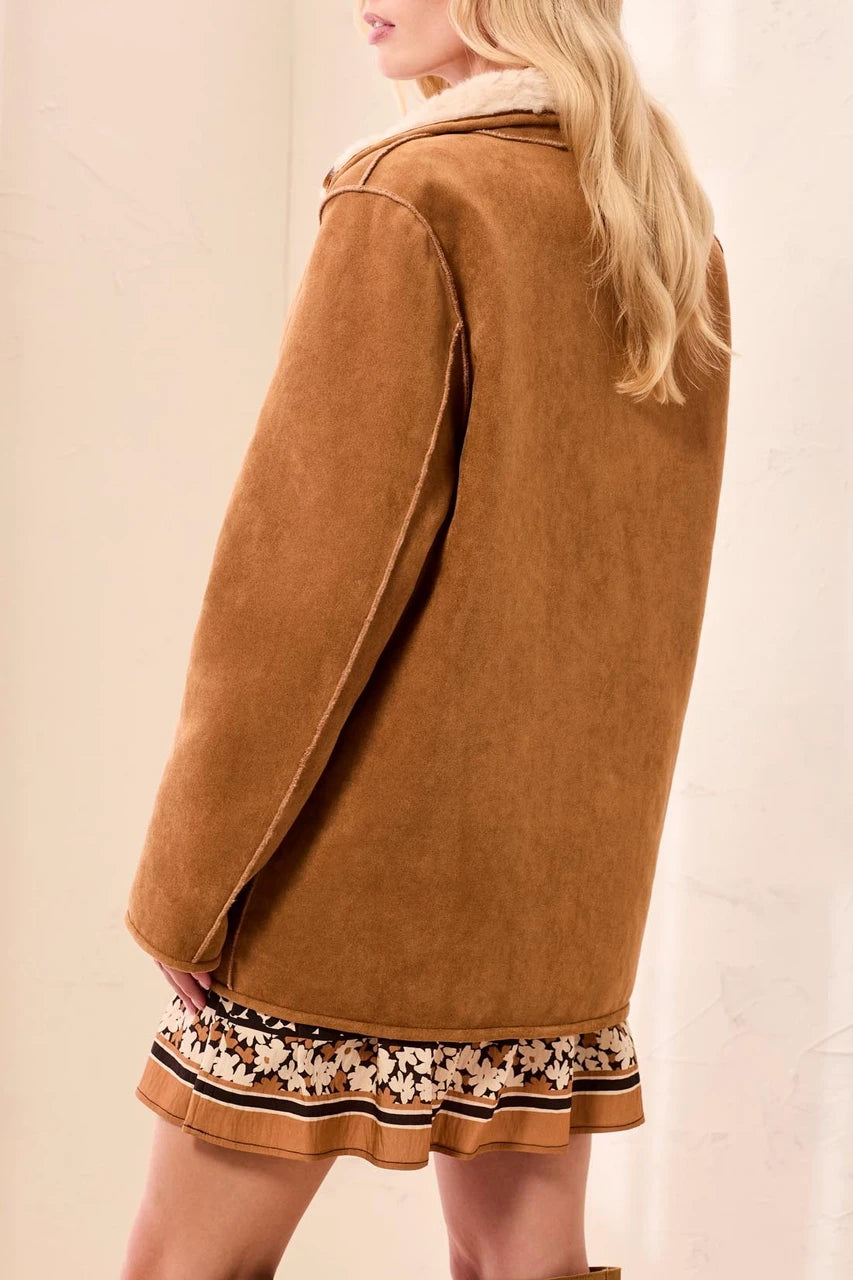 back view of woman in suede coat 