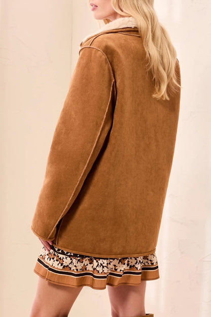 back view of woman in suede coat 