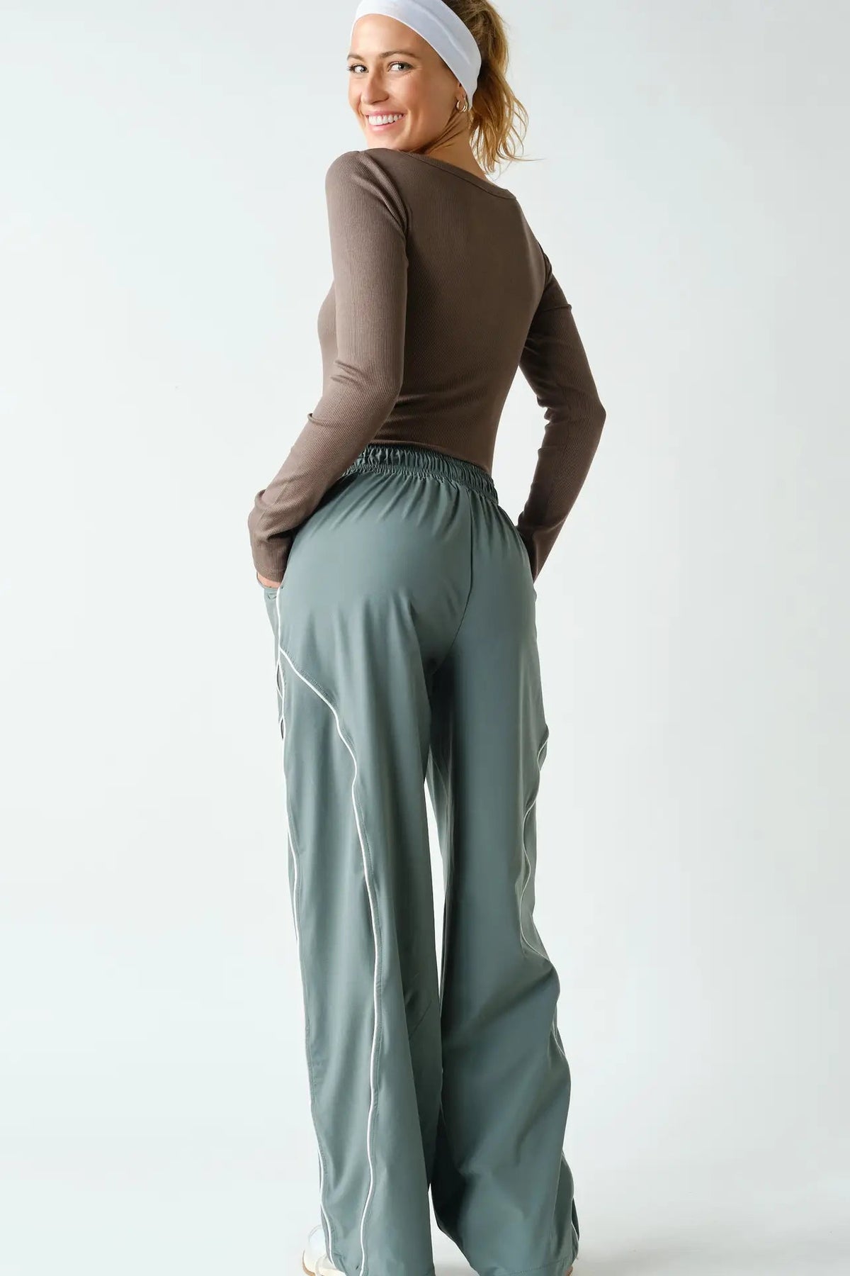 back view of woman in long sleeve tee and pants