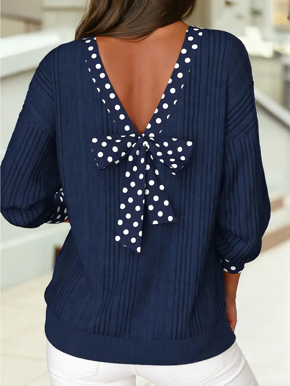woman wearing polka dot navy knit