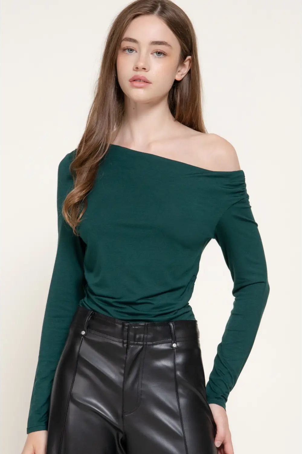 woman in green top and black pants