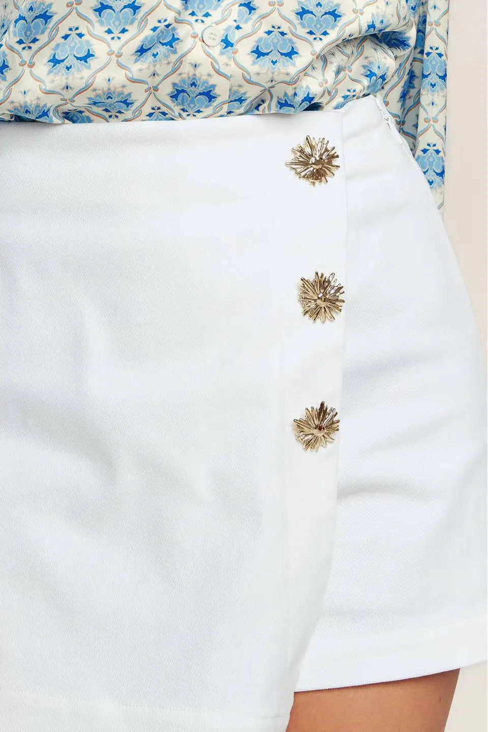 close up of button on white skort