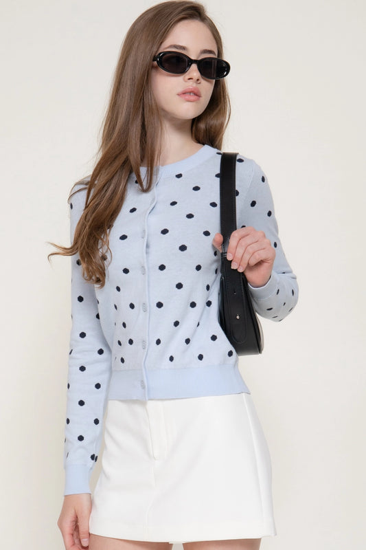 woman wearing blue cardigan with white skirt 