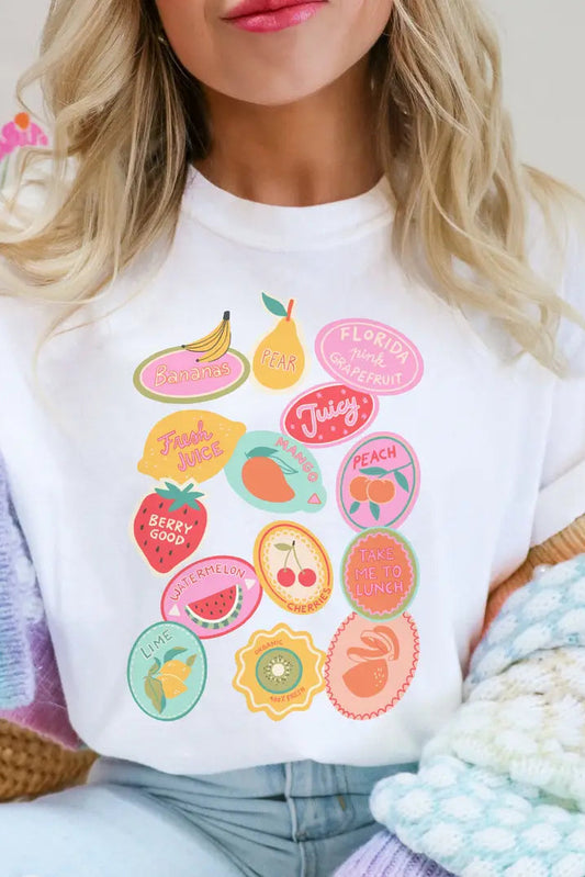 Person wearing a white sweatshirt with colorful fruit-themed graphics